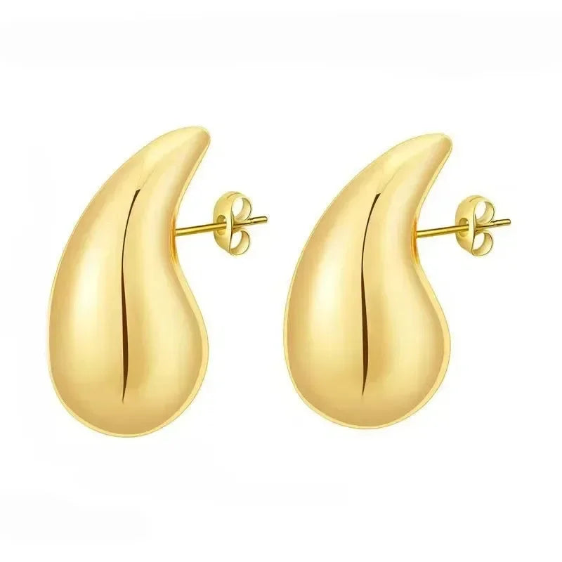 Gold teardrop-shaped earrings on a white background