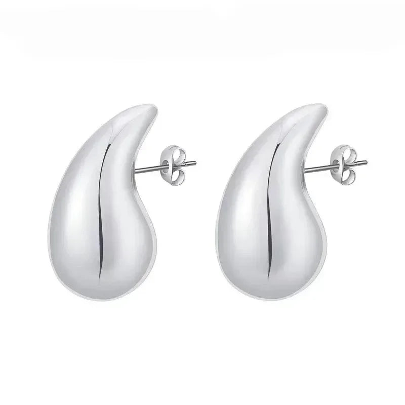 Pair of silver teardrop earrings on a white background