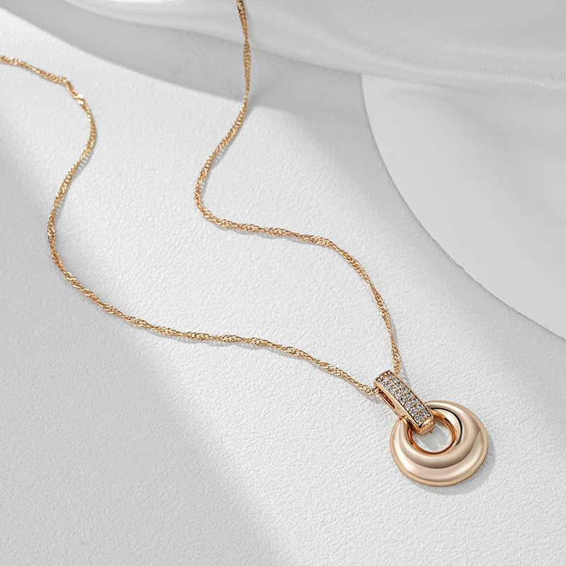 Rose gold pendant necklace displayed flat with a twisted chain on a white surface