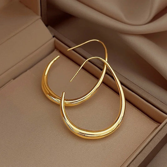 Sleek gold crescent hoop earrings with a modern open design