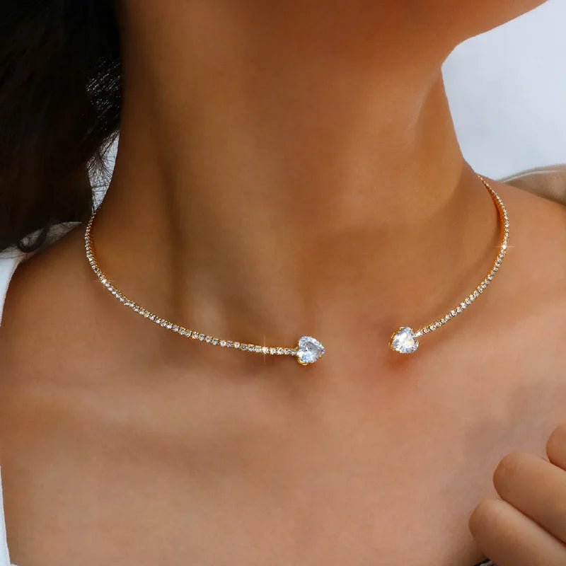 Woman wearing a gold sparkling solitaire choker necklace with cubic zirconia stones, styled for an elegant look.